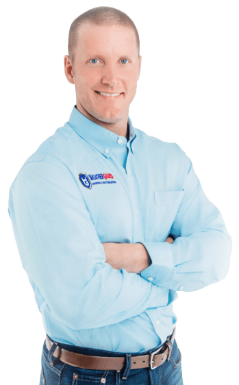 Weatherguard Roofing & Restoration | A Weatherguard Roofing and Restoration team member wearing a blue company shirt with an embroidered company logo with his arms folded and smiling