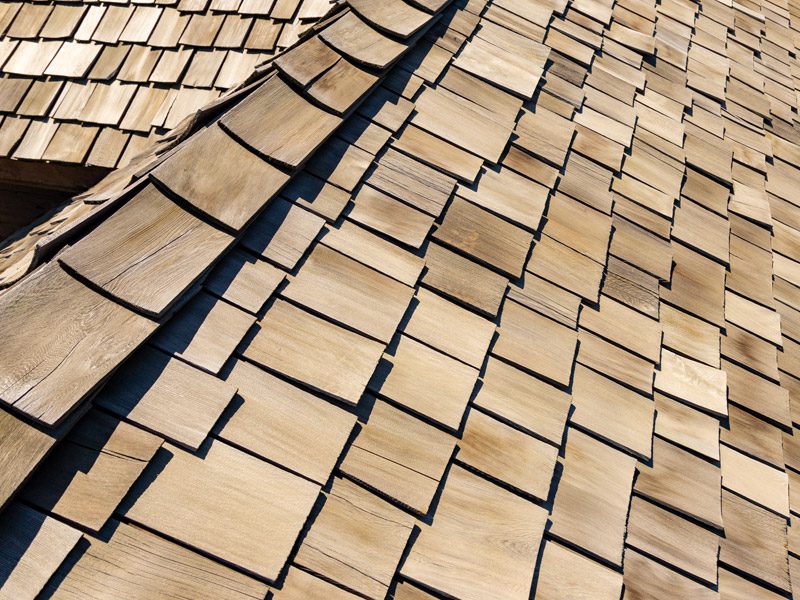 Weatherguard Roofing & Restoration | A close up view of cedar wood shingles on the top of a house