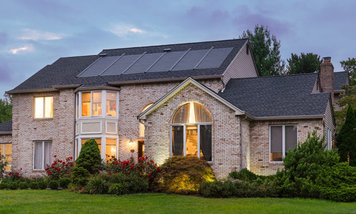 weatherguard-home-with-solar-shingles-at-dusk