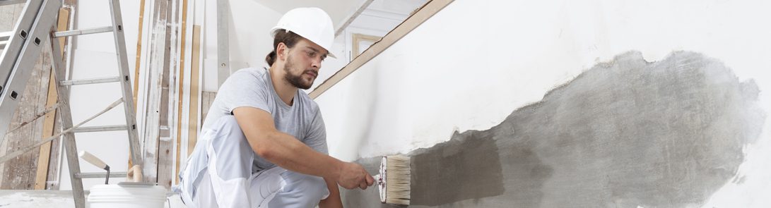 Weatherguard Roofing & Restoration | Professional painter painting the interior wall of a house damaged by a storm