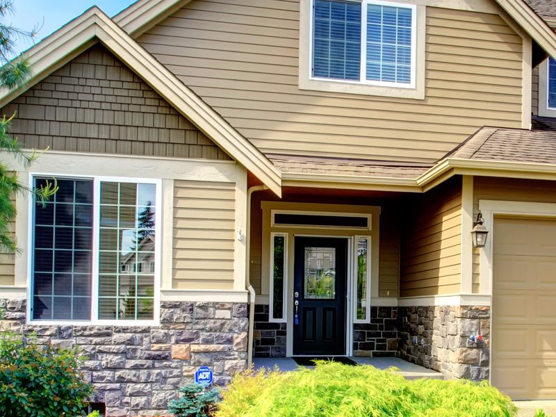 Weatherguard Roofing & Restoration | Brand new cedar shake roof on a craftman's style home surrounded by lush shrubbery